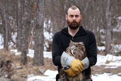 Jonathan Slaght holding a blakiston's fish owl